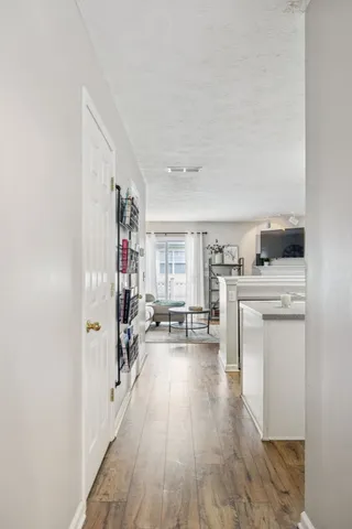 a view of a living room with furniture and wooden floor