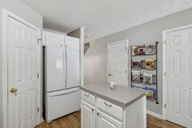 a kitchen with stainless steel appliances a refrigerator and a stove top oven