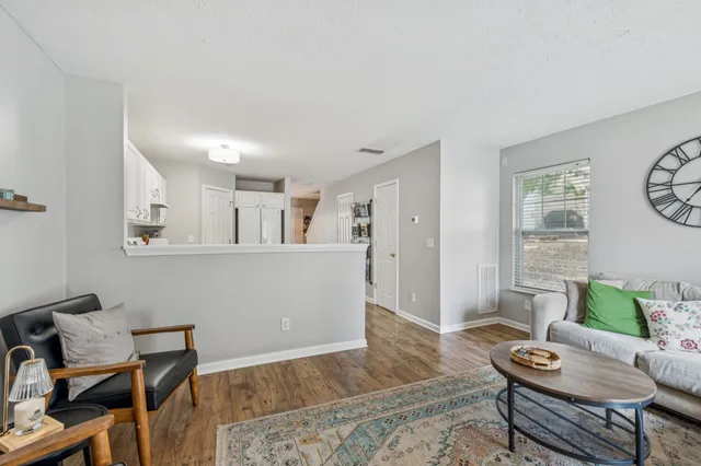 a living room with furniture and wooden floor
