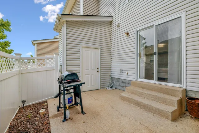 a view of a room with furniture and a window