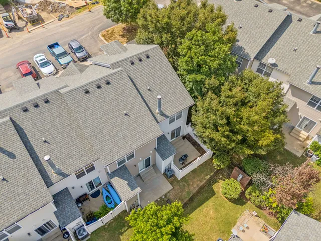an aerial view of a house with a yard