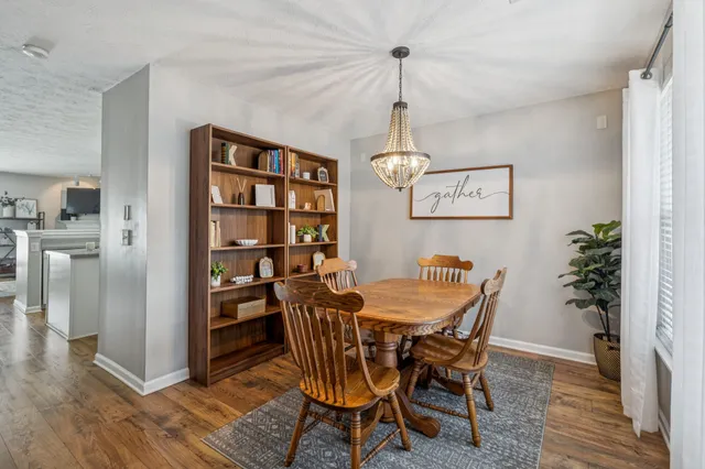 a view of a dining room with furniture wooden floor and a chandelier