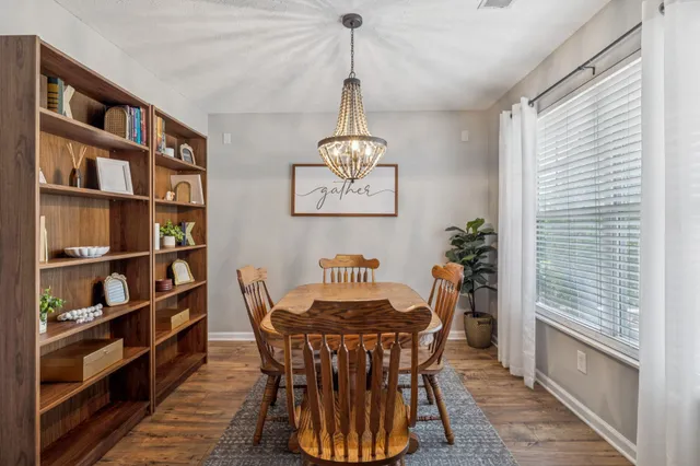a dining room with furniture and a window