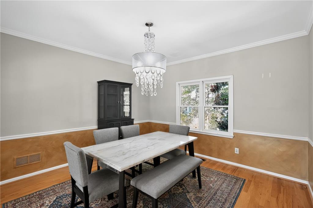 10950 Regal Forest Drive Suwanee, GA 30024 - Photo 12 of 52 a view of a dining room with furniture window and wooden floor