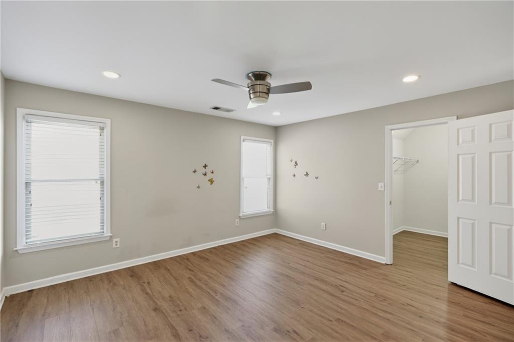 10950 Regal Forest Drive Suwanee, GA 30024 - Photo 14 of 52 wooden floor in an empty room with a window