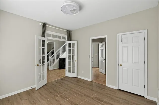 a kitchen with stainless steel appliances a stove top oven a refrigerator a sink and dishwasher with wooden floor