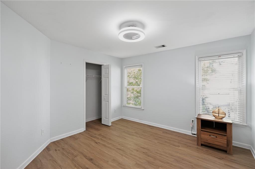 10950 Regal Forest Drive Suwanee, GA 30024 - Photo 18 of 52 a view of an empty room with wooden floor and a window