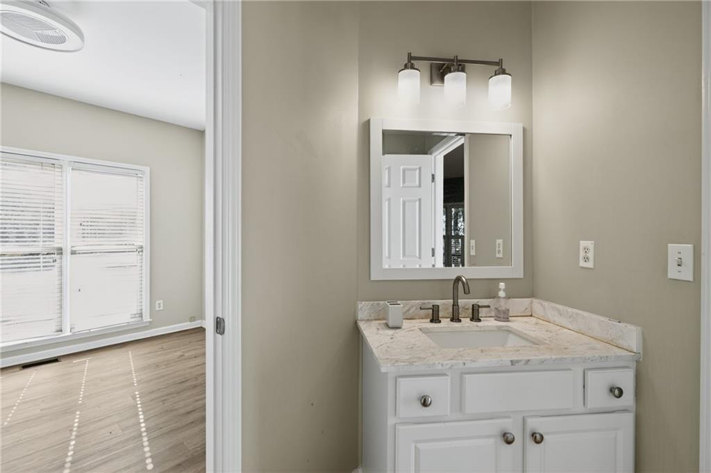 10950 Regal Forest Drive Suwanee, GA 30024 - Photo 22 of 52 a bathroom with a granite countertop sink and a mirror