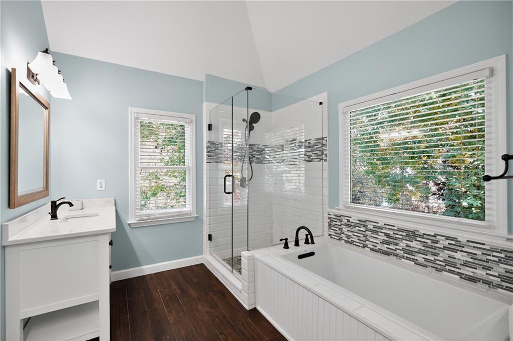 10950 Regal Forest Drive Suwanee, GA 30024 - Photo 23 of 52 a bathroom with a tub sink and window