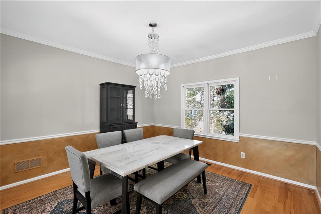 10950 Regal Forest Drive Suwanee, GA 30024 - Photo 31 of 52 a view of a dining room with furniture window and wooden floor