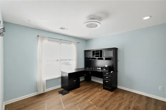 an empty room with closet and windows