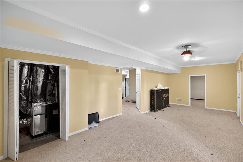 10950 Regal Forest Drive Suwanee, GA 30024 - Photo 44 of 52 an empty room with closet and windows
