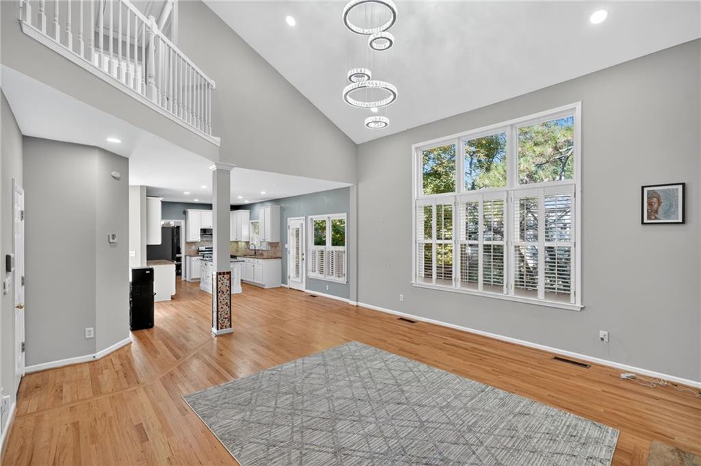 10950 Regal Forest Drive Suwanee, GA 30024 - Photo 7 of 52 a view of livingroom with hardwood floor and a ceiling fan