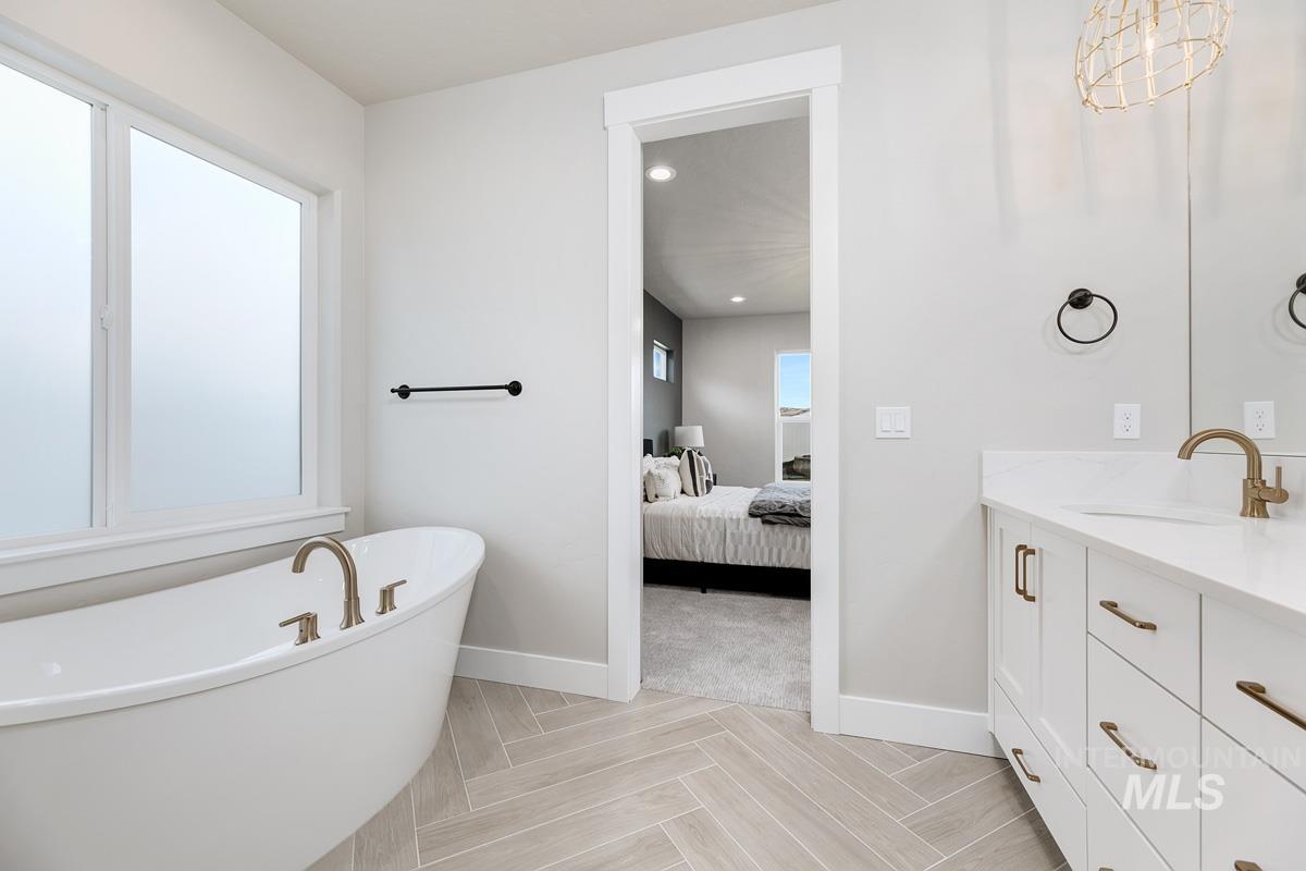 13544 North Ruffed Grouse Way Boise, ID 83714 - Photo 14 of 44 Full bath featuring a freestanding tub, vanity, connected bathroom, and recessed lighting