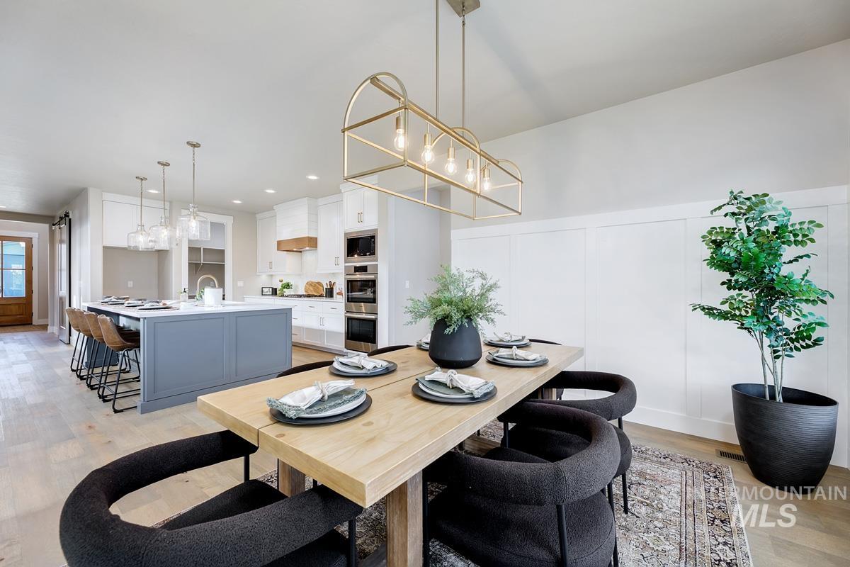 13544 North Ruffed Grouse Way Boise, ID 83714 - Photo 9 of 44 Dining room with light wood finished floors, a decorative wall, wainscoting, and recessed lighting