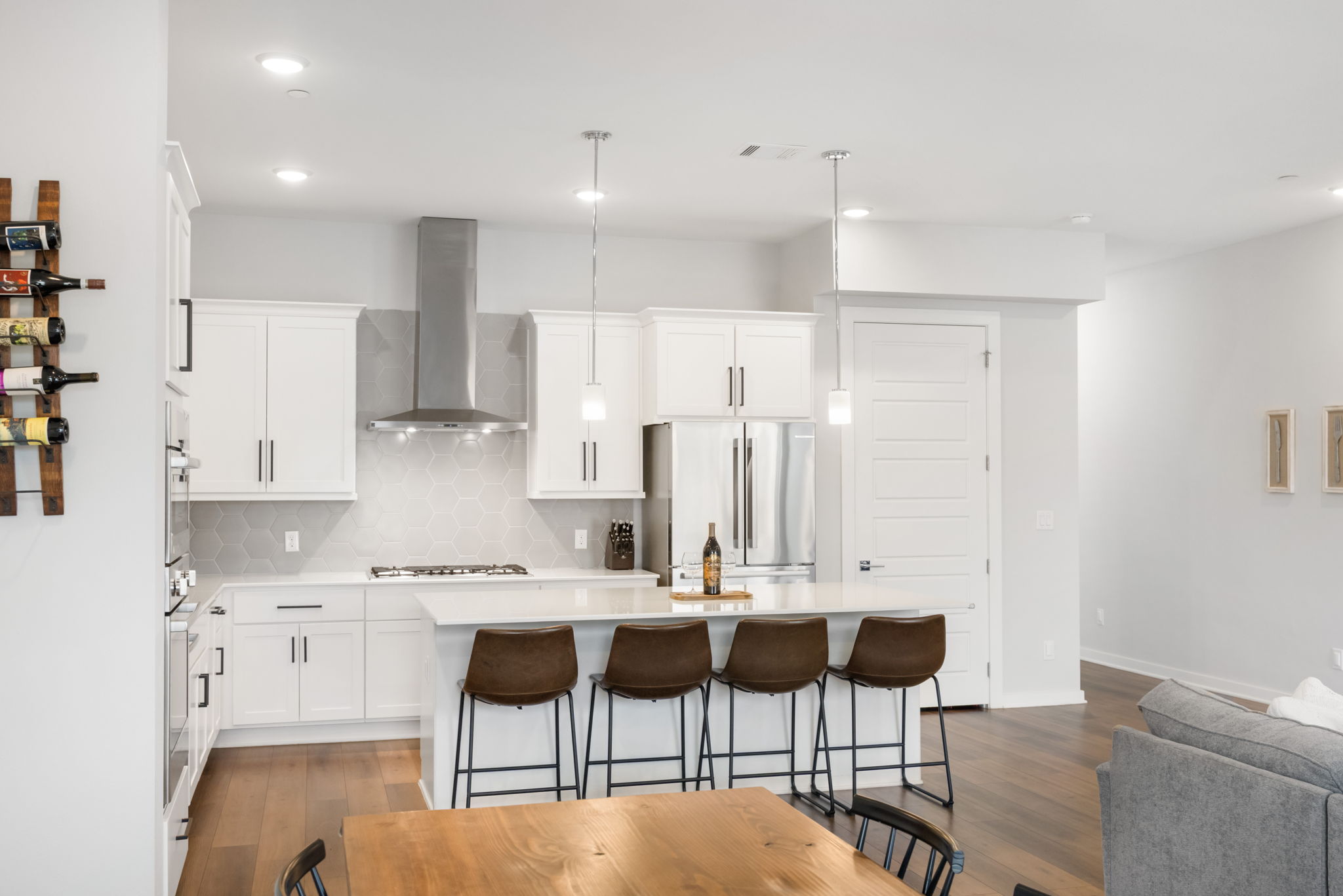 1417 Kramer Lane, Unit 14 Austin, TX 78758 - Photo 13 of 33 Kitchen with white cabinets, a breakfast bar area, light wood-type flooring, and a center island
