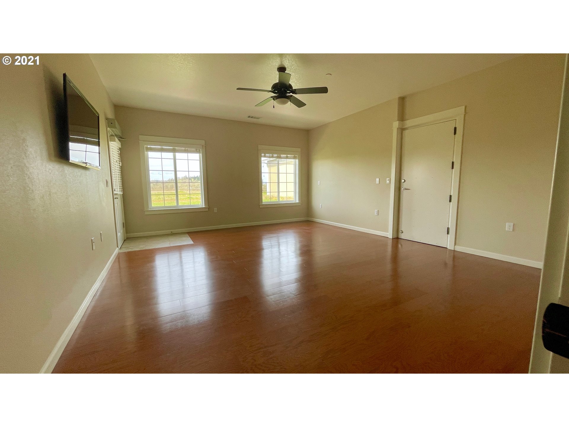 8765 Southwest River Road Hillsboro, OR 97123 - Photo 13 of 31 a open hall with a floor to ceiling window and wooden floor