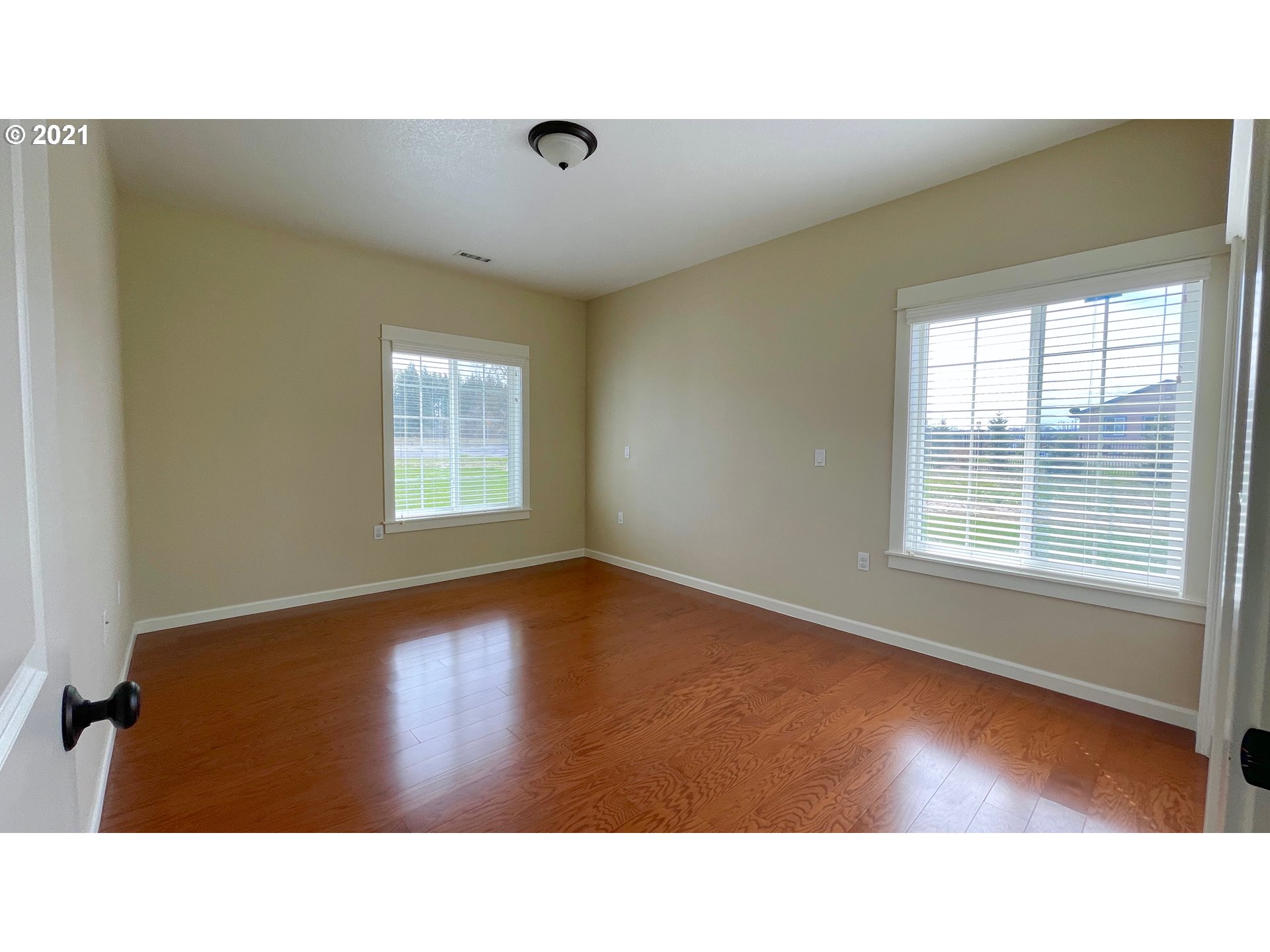 8765 Southwest River Road Hillsboro, OR 97123 - Photo 17 of 31 a room with a window and wooden floor