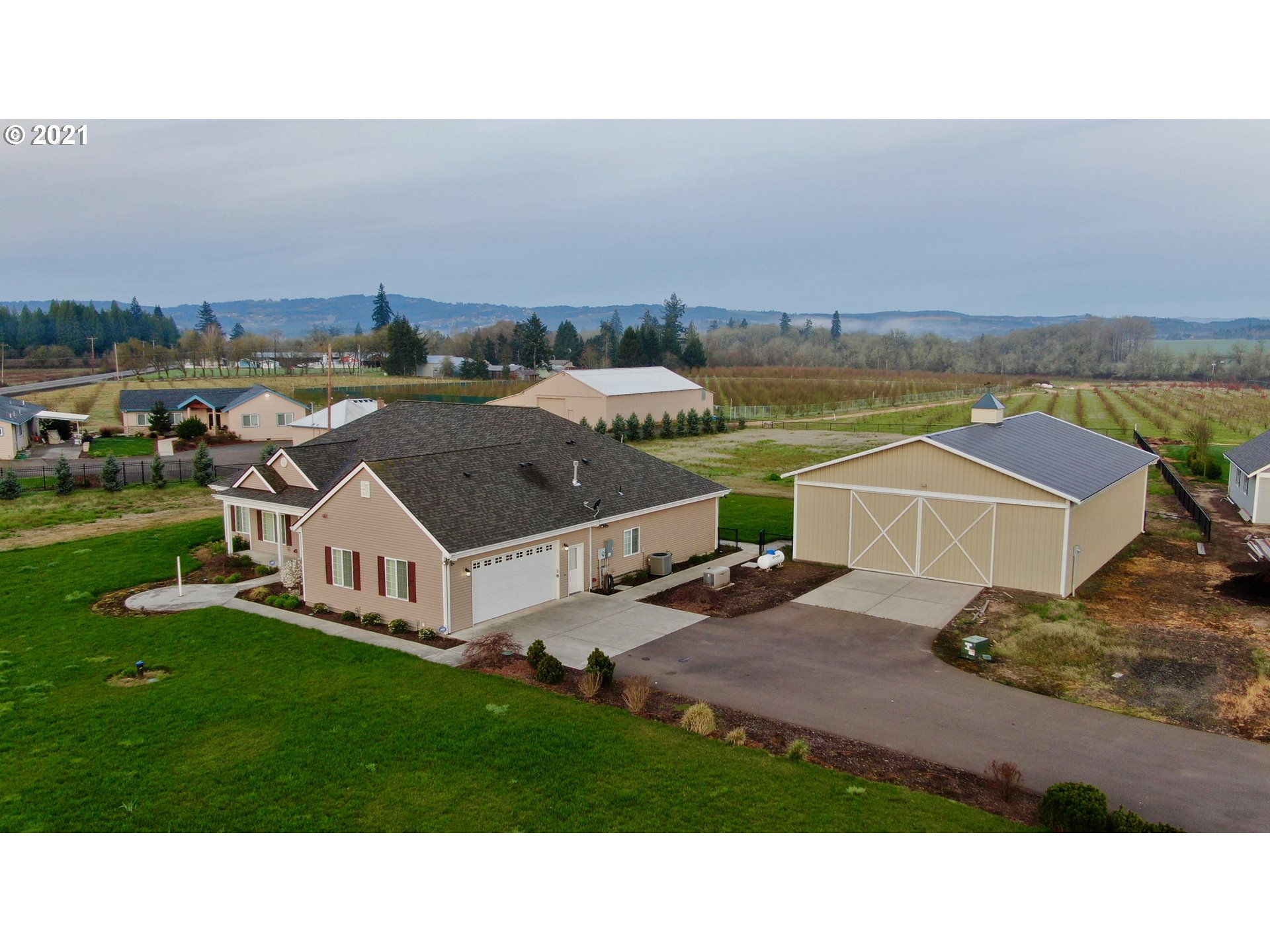 8765 Southwest River Road Hillsboro, OR 97123 - Photo 3 of 31 a aerial view of a house with a garden