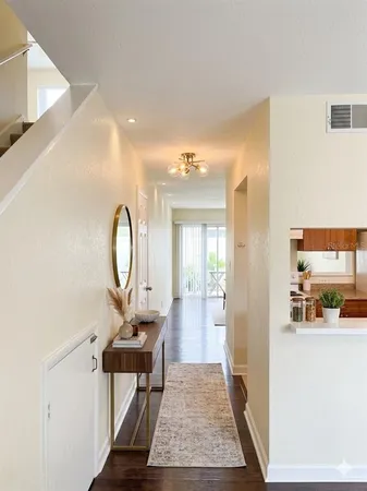 a living room with furniture and a mirror