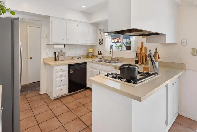 a kitchen with a stove a sink and a refrigerator