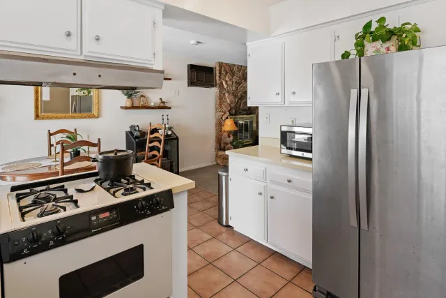 a kitchen with stainless steel appliances a refrigerator stove and sink