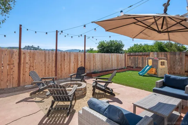 a view of a patio with table and chairs under an umbrella