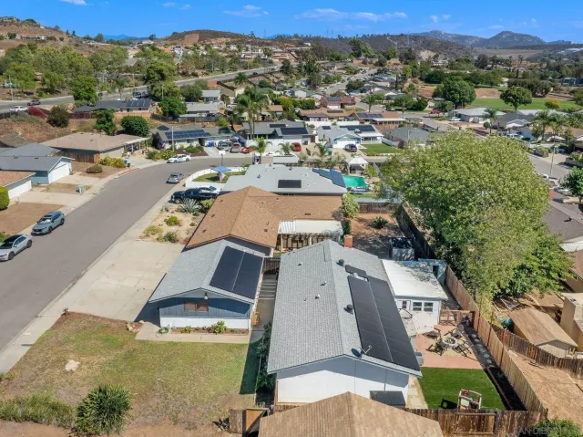 an aerial view of residential houses with outdoor space