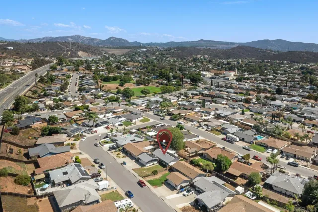 an aerial view of residential houses with city view