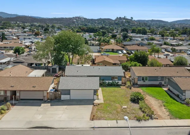 a view of a living room with a flat screen tv and a ceiling fan