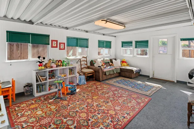 a bedroom with furniture and a rug