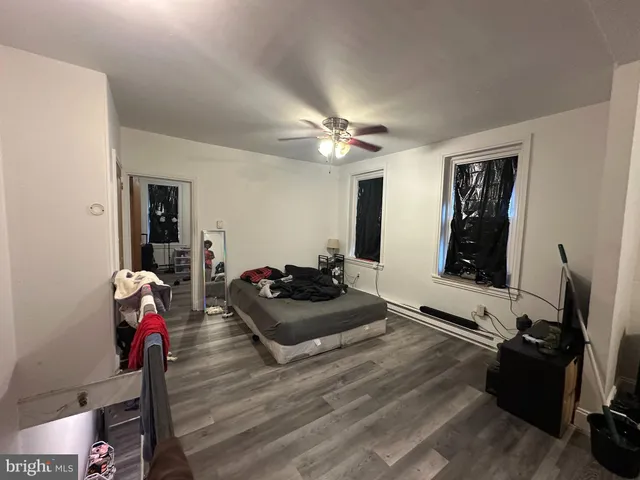 a bathroom with a granite countertop shower and a toilet