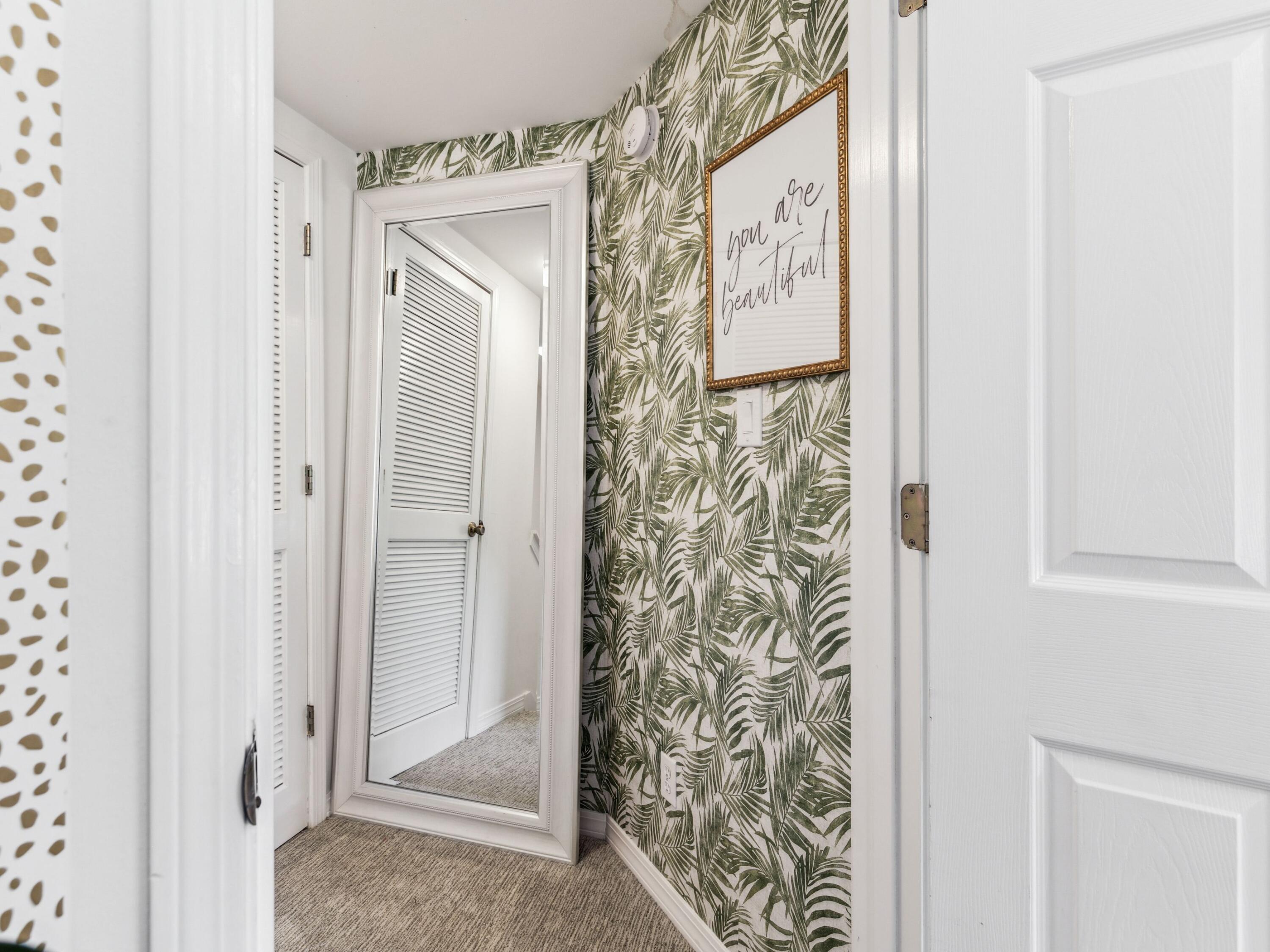 8855 Baypine Drive Miramar Beach, FL 32550 - Photo 33 of 49 a view of a hallway with paintings on the wall