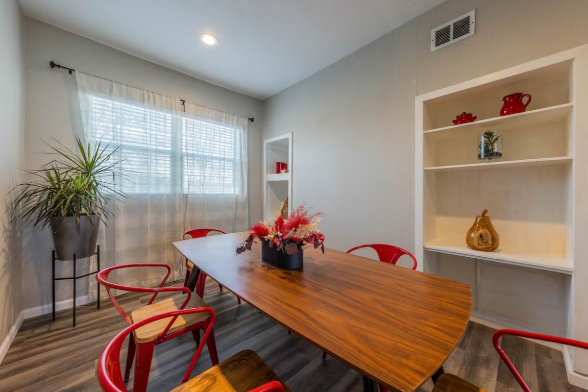 1212 North Main Street Elgin, TX 78621 - Photo 11 of 31 Dining room featuring built in shelves and dark wood-style floors