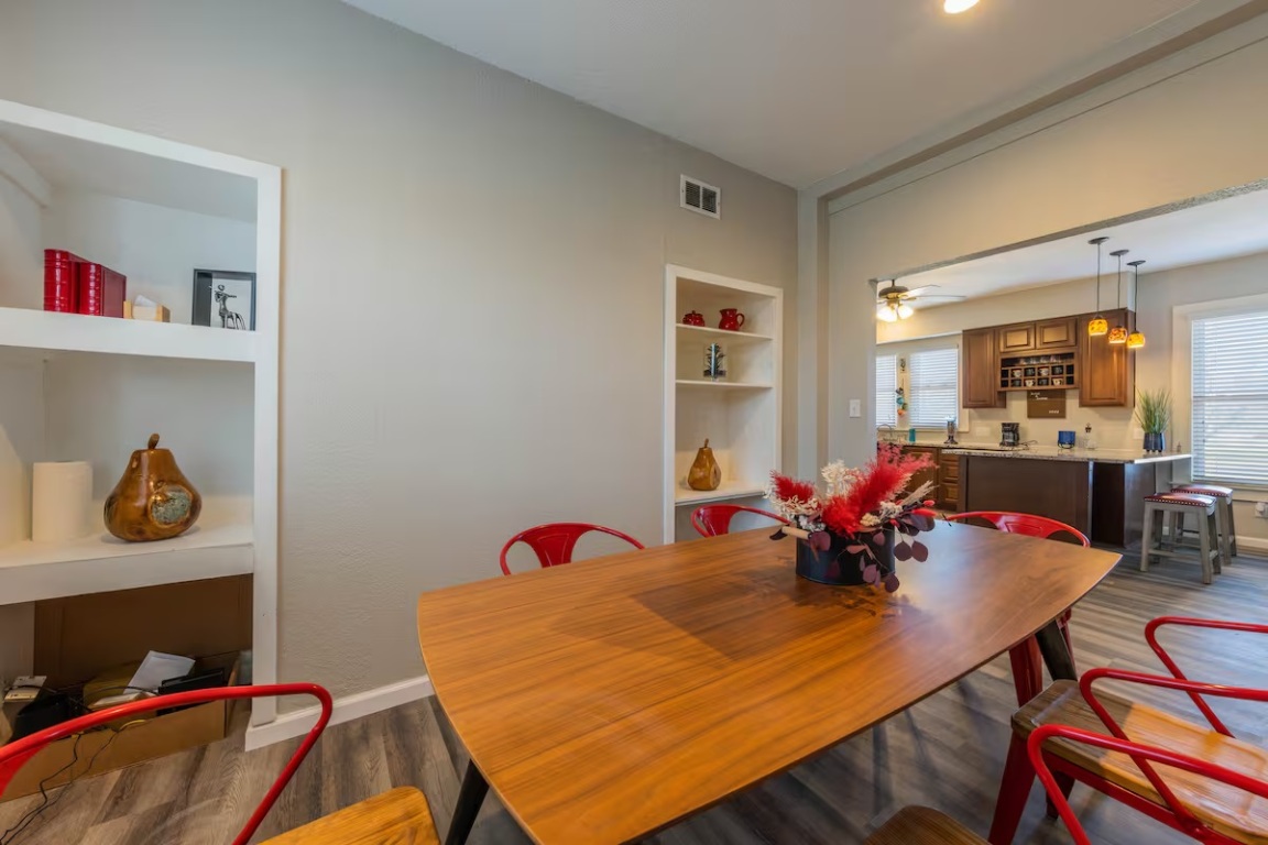 1212 North Main Street Elgin, TX 78621 - Photo 12 of 31 Dining room featuring built in features, dark wood-type flooring, and ceiling fan