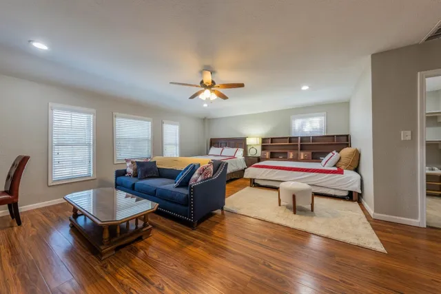 a living room with furniture and a wooden floor