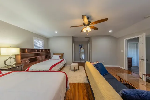 a bed room with two bed and a chandelier