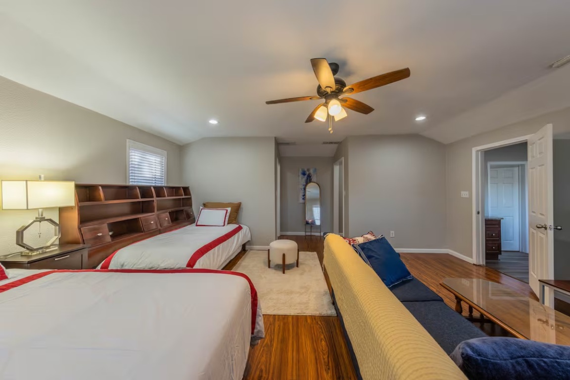 1212 North Main Street Elgin, TX 78621 - Photo 17 of 31 Bedroom featuring wood finished floors, a ceiling fan, recessed lighting, and vaulted ceiling