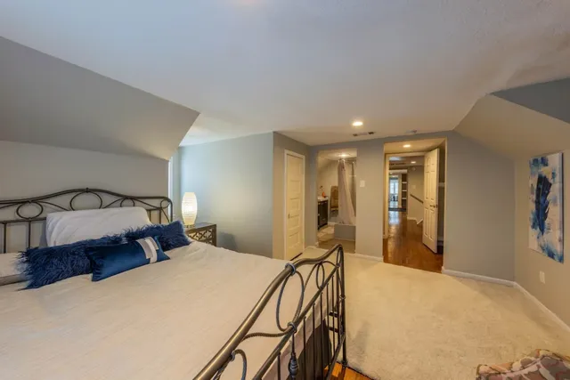 a bedroom with a large bed and a dresser