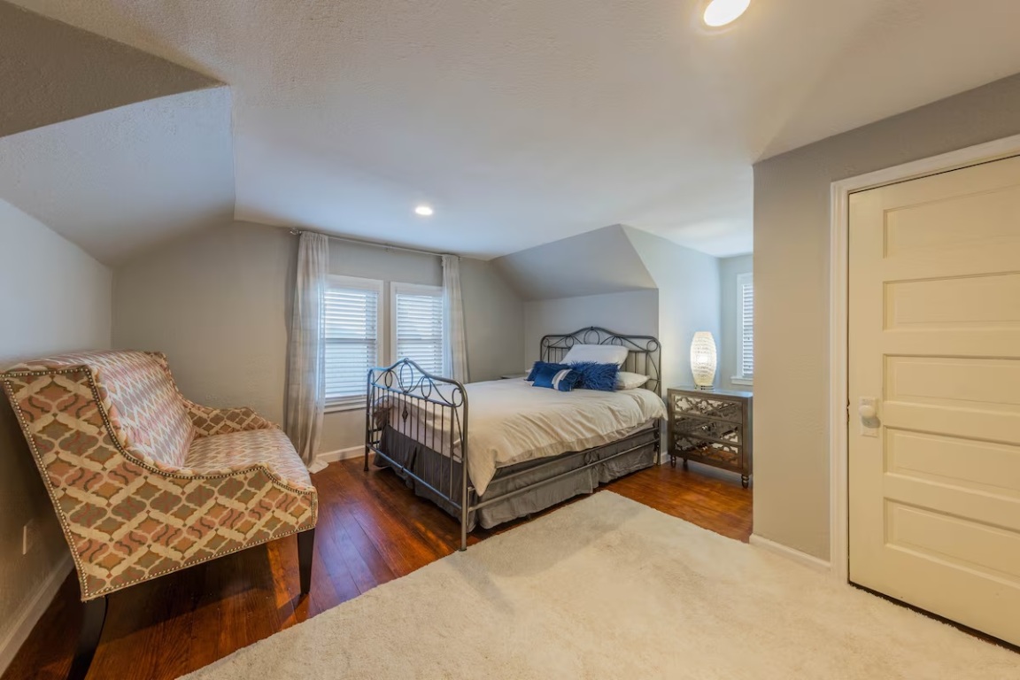 1212 North Main Street Elgin, TX 78621 - Photo 19 of 31 Bedroom featuring vaulted ceiling, hardwood / wood-style floors, recessed lighting, and a textured ceiling