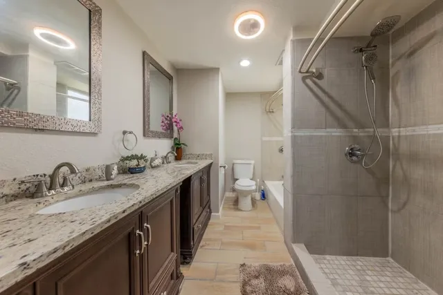 a bathroom with a granite countertop sink mirror and double