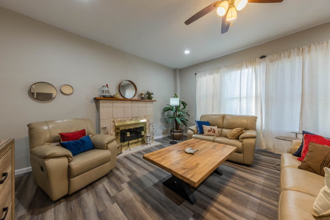 1212 North Main Street Elgin, TX 78621 - Photo 2 of 31 Living area featuring ceiling fan, a fireplace, dark wood-type flooring, and recessed lighting