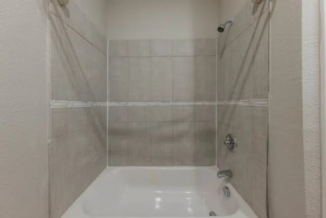 a bathroom with a shower and a bathtub