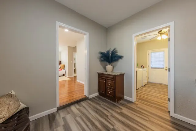 a view of hallway with wooden floor and a rug