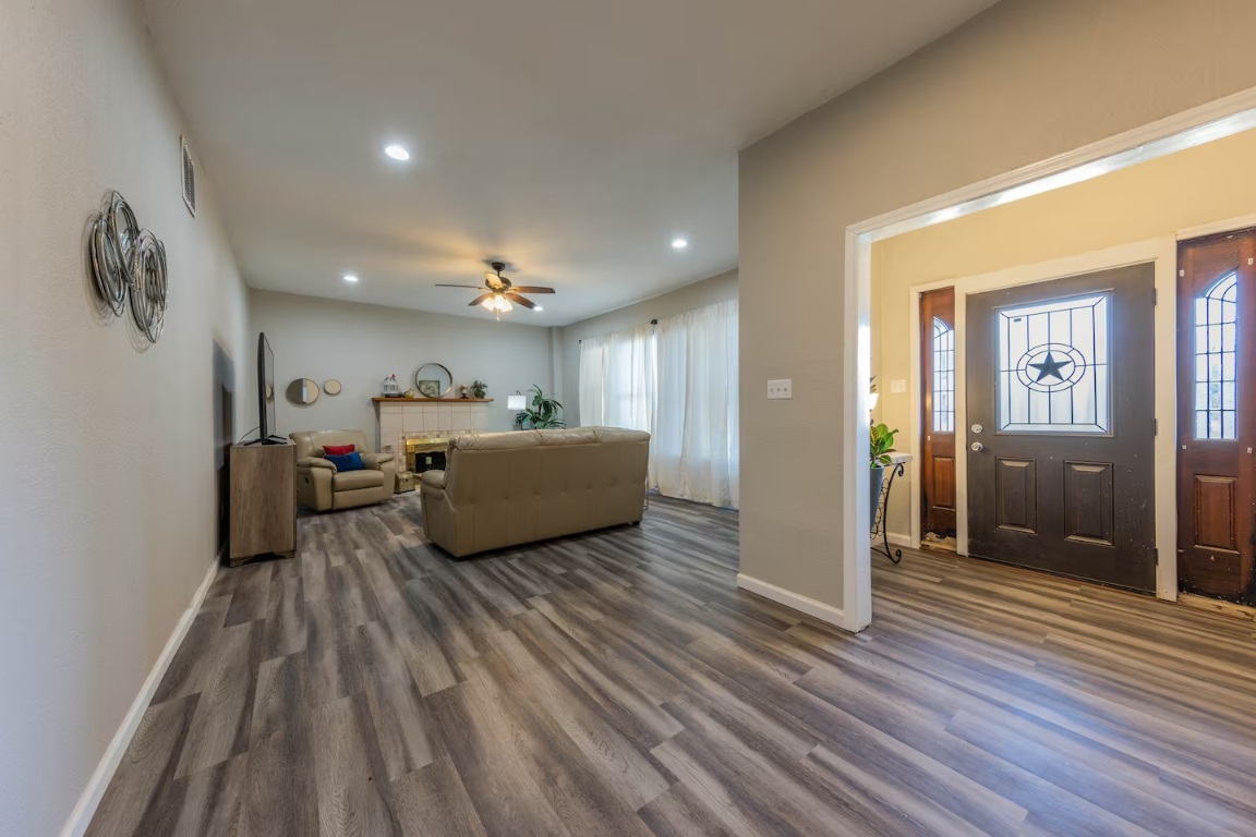 1212 North Main Street Elgin, TX 78621 - Photo 4 of 31 Living room featuring dark wood finished floors, recessed lighting, ceiling fan, and plenty of natural light