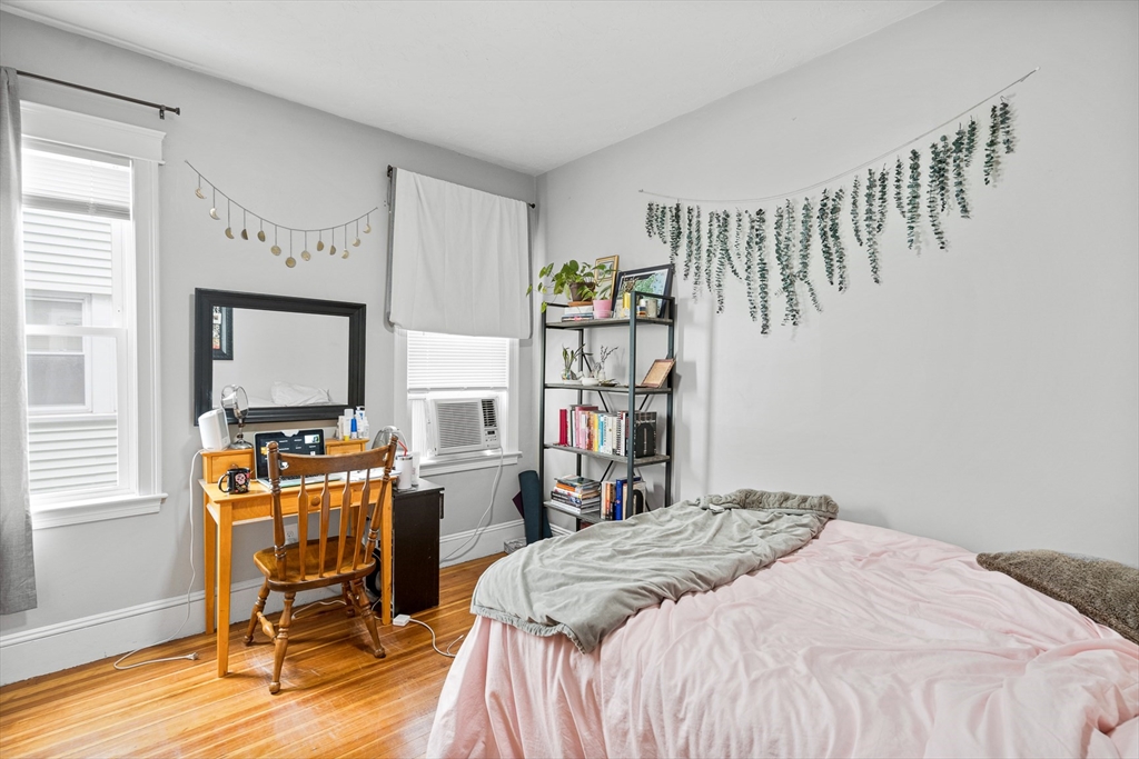 79 Saxton Street, Unit 3 Boston, MA 02125 - Photo 1 of 12 a bed room with a bed and a chair