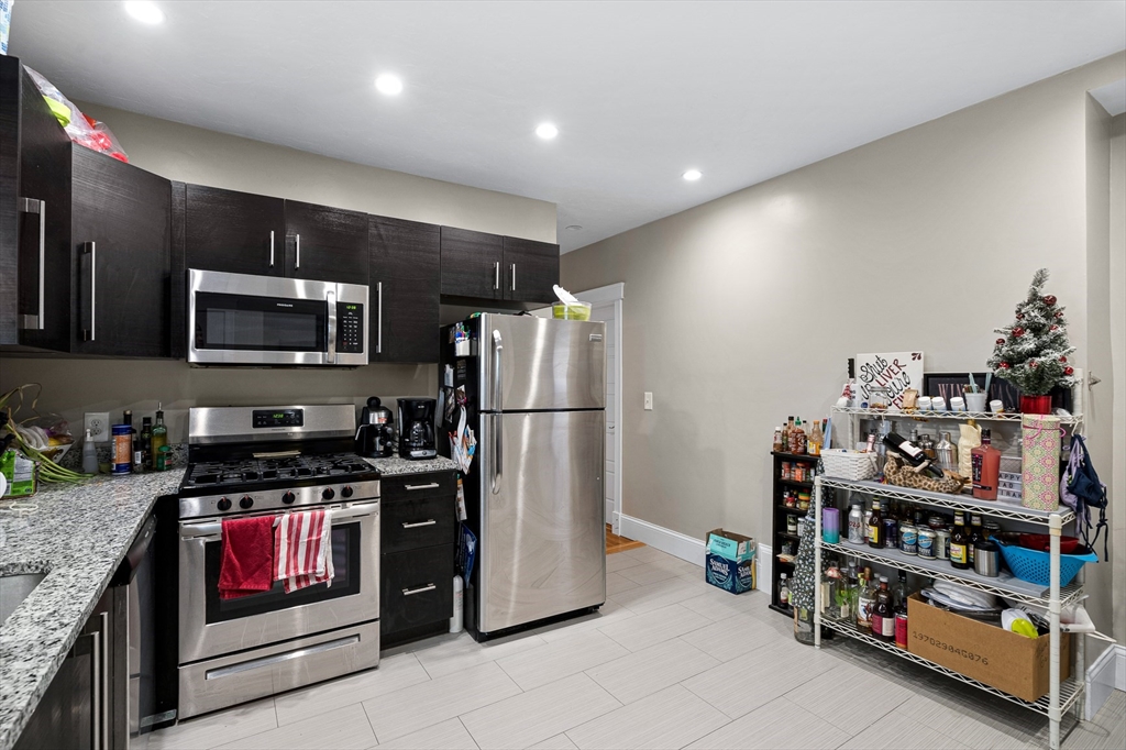 79 Saxton Street, Unit 3 Boston, MA 02125 - Photo 11 of 12 a kitchen with refrigerator and cabinets