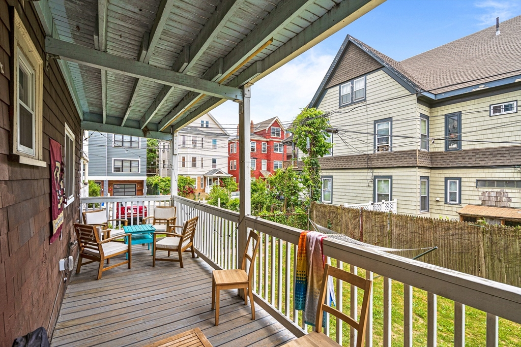 79 Saxton Street, Unit 3 Boston, MA 02125 - Photo 12 of 12 a view of a balcony with chairs and wooden floor