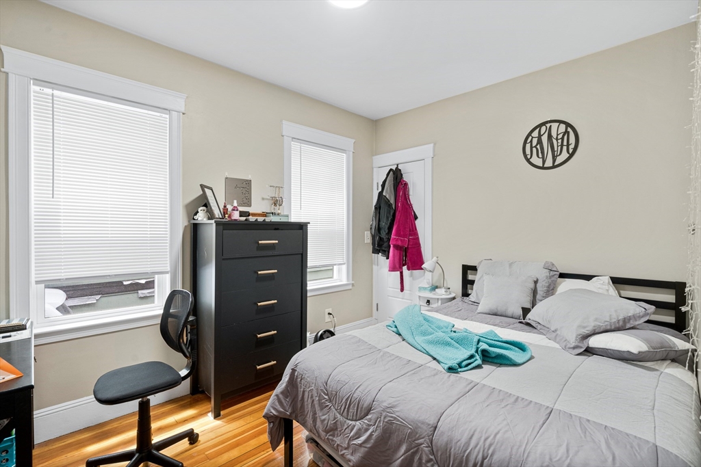 79 Saxton Street, Unit 3 Boston, MA 02125 - Photo 2 of 12 a bedroom with a bed and a dresser