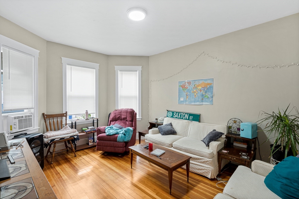 79 Saxton Street, Unit 3 Boston, MA 02125 - Photo 3 of 12 a living room with furniture and a large window